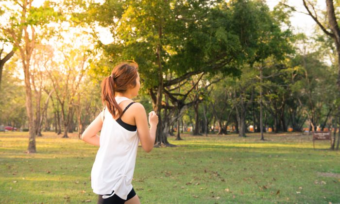 Young woman running in wood, training and exercising for trail run marathon endurance in morning sunrise. Fitness healthy lifestyle concept. Vintage effect style pictures.